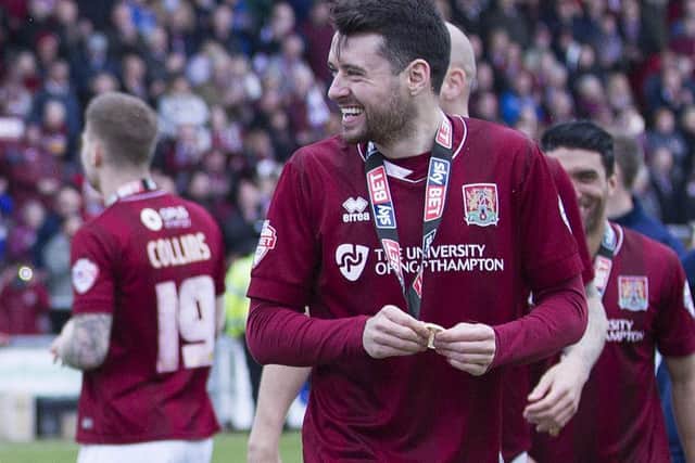 Brendan Moloney, pictured here enjoying the title celebrations at Sixfields on Saturday, is to undergo an operation on his knee injury