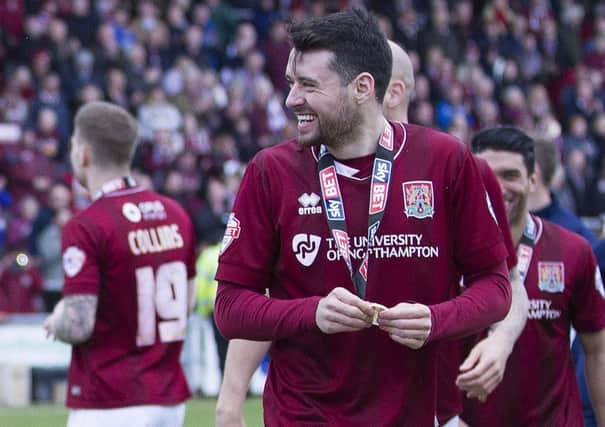 Brendan Moloney, pictured here enjoying the title celebrations at Sixfields on Saturday, is to undergo an operation on his knee injury