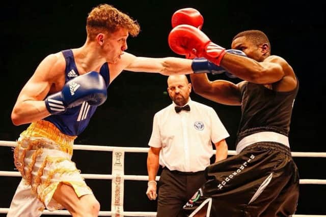 ON TARGET - Carl Fail lands a punch on Ekow Essuman