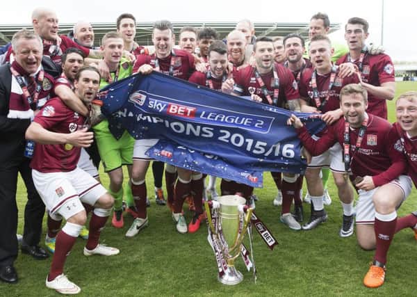 Chris Wilder celebrates winning Sky Bet League Two with the Cobblers players