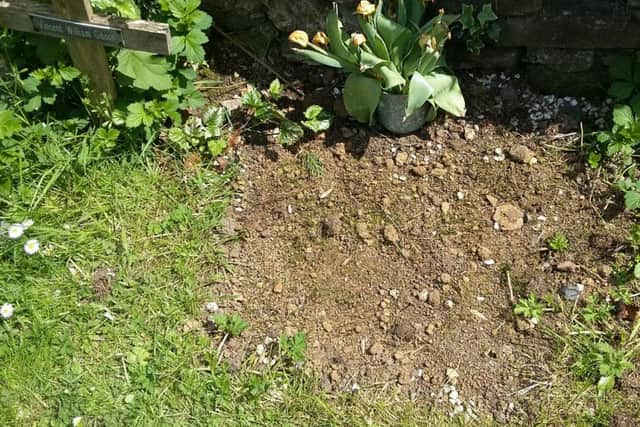 Wayne Perrett says a church decision to remove tributes to his mother left where he and family placed her ashes six years ago, has caused distress.
