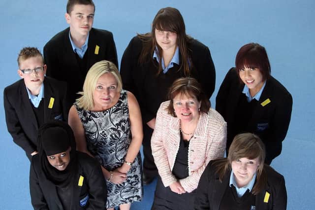headteacher Jane Herriman (centre right) with pupils and staff