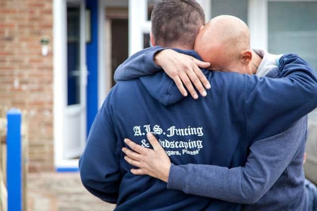 Addam Smith and Keith Ellick embrace, after Mr Smith kindly rennovated his friend's house and garden, when he learned the 41-year-old was dying of cancer.