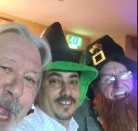Jimmy Powell (left) with Royal Oak landlord Bhola Upreti (centre) and fellow pub patron celebrate St Patrick's Day