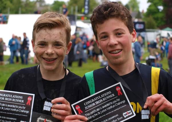 SHOWING THEIR METTLE - Silson Joggers Michael Rapson and Alfie Long are all smiles after completing the Junior IronRun.