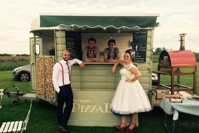 At a wedding they were hired for, with the old oven visible