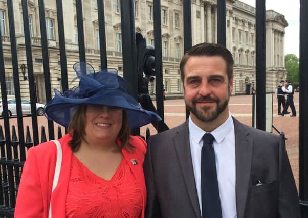 Emergency planning officer Joanne Maddams with her husband Matthew at Buckingham Palace.
