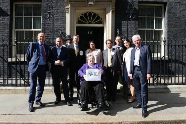 Dora Shergold hands in the petition at 10 Downing Street.