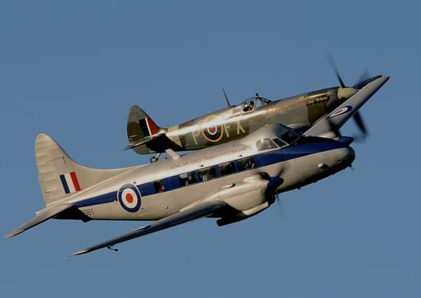 The de Havilland Devon flies close to the Spitfire