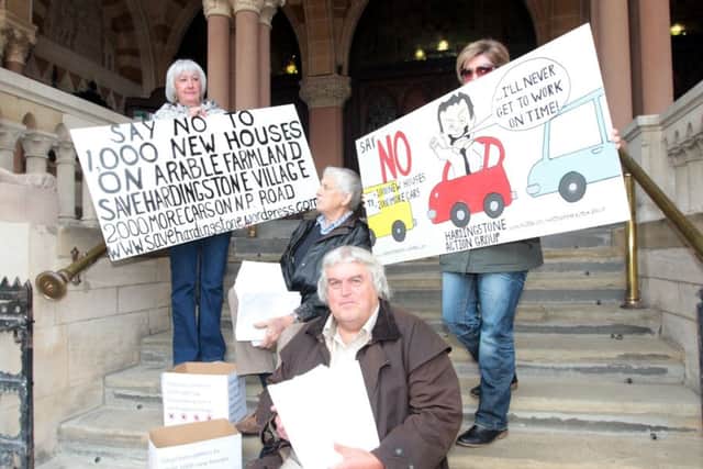 A group of residents from Hardingstone delivered  700 letters to  the Guildhall to fight the original 1,000 homes plan in 2013. Adrian can be seen at the front.