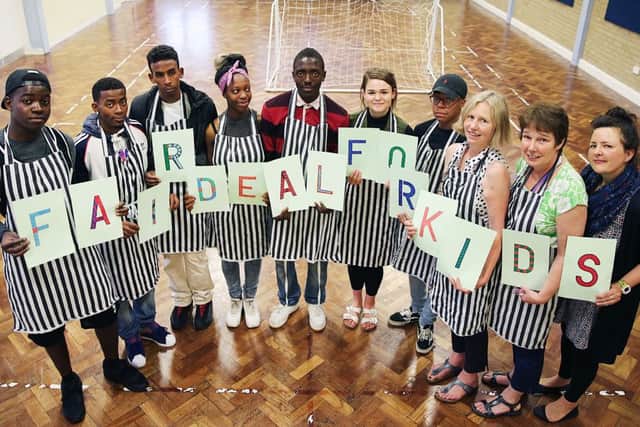 Children from the Springs Family Centre hold up a Fair Deal for Kids banner as part the Chron's anti-poverty campaign.
