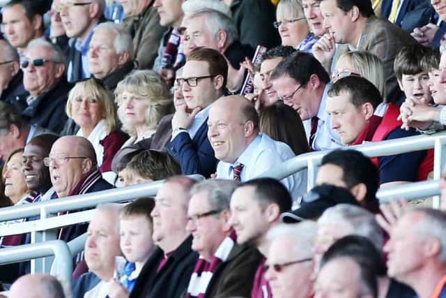David Cardoza, centre, was chairman of Northampton Town through 2013 and 2014.