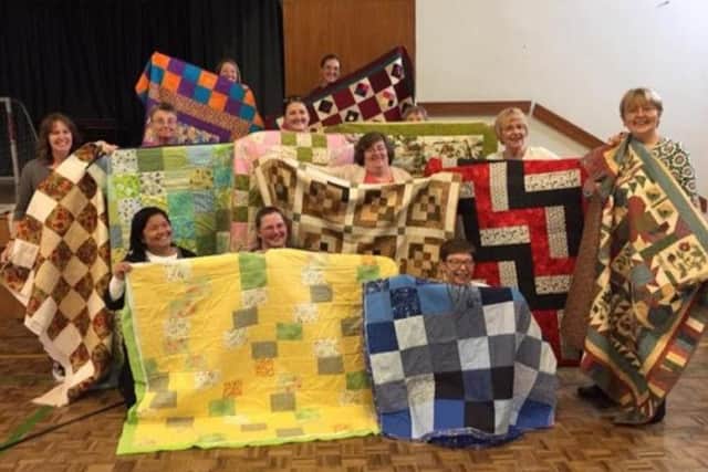 The ladies of the Church of the Latter Day Saints Northampton with their quilts
