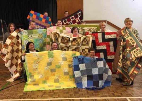 The ladies of the Church of the Latter Day Saints Northampton with their quilts