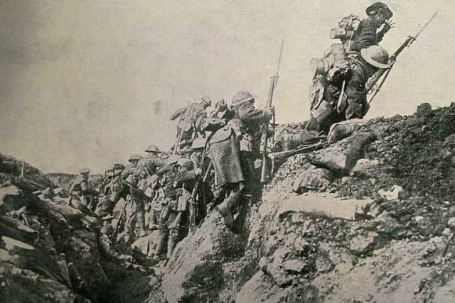 Soldiers leave their trench under enemy fire.