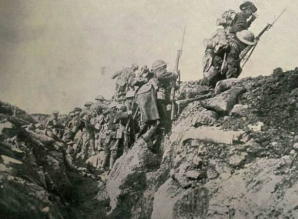 Soldiers leave their trench under enemy fire.