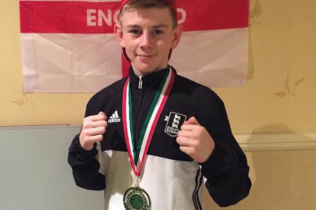 Eithan James shows off his silver medal