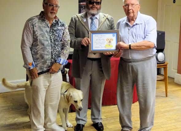 Basil Root was presented with a certificate to mark his 35 years of service with Northampton guide dogs