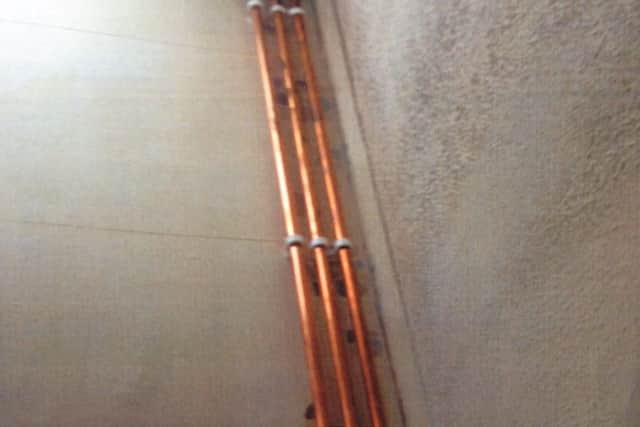 Pictures from inside the home of an 80-year-old woman in the East of Northampton. Photos show piping left exposed at the property.