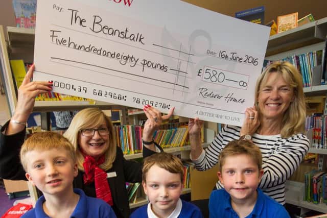 Redrow Sales Consultant Olga Hagan presents the Â£580 cheque to Teresa Quigly from the Beanstalk Reading Partnership. watched by yr 3 pupils Ethan, Sam and George. June 16 2016Matthew Power Photographywww.matthewpowerphotography.co.uk07969 088655mpowerphoto@yahoo.co.uk@mpowerphoto