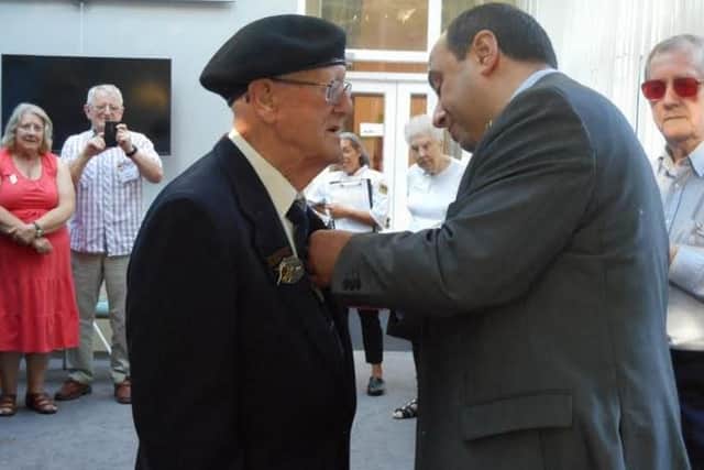 Les Hammond being presented with the honour by French Consul Jean-Claude Lafontaine