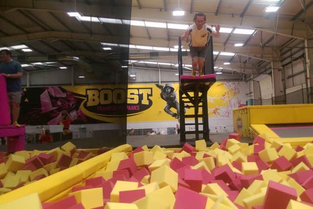 A member of staff dives into the foam pit at the new Boost Trampoline Park in Northampton.