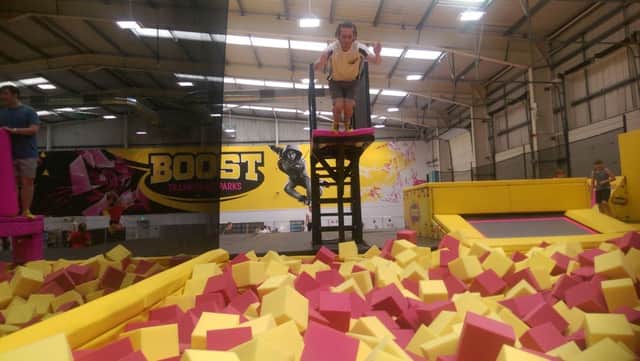 A member of staff dives into the foam pit at the new Boost Trampoline Park in Northampton.