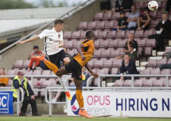 HIGH CLIMBER - Harry Beautyman heads home for the Cobblers to make it 1-1 against Wolves on Tursday night (Pictures: Kirsty Edmonds)