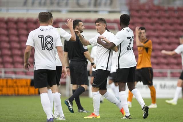 WELL DONE, MATE - Harry Beautyman accepts the congratulations after heading home the Cobblers' first-half equaliser against Wolves (Picture: Kirsty Edmonds)