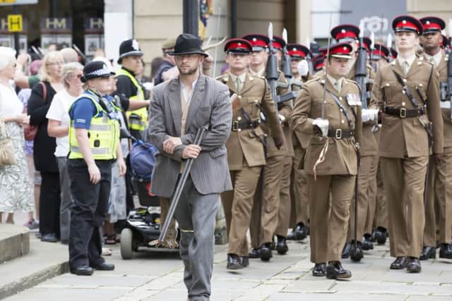 Soldiers from The Poachers parade through Northampton before laying up their Regimental Colour at Church of the Holy Sepulchre NNL-160730-162723009
