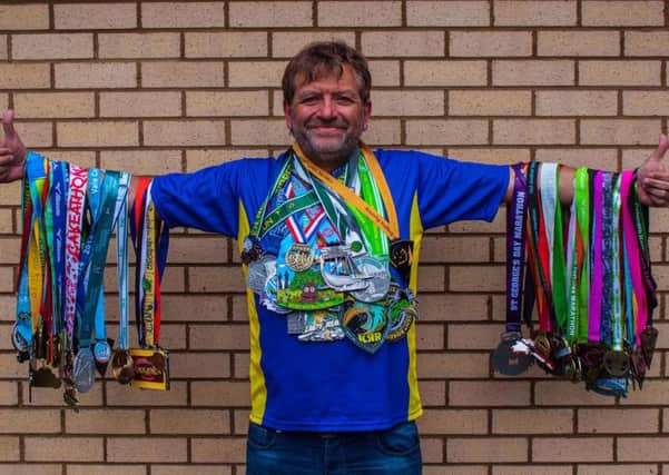 Stuart Mellows with his haul of medals