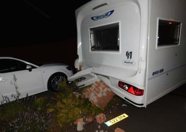 The caravan rolled into a brick wall and a neighbour's car.