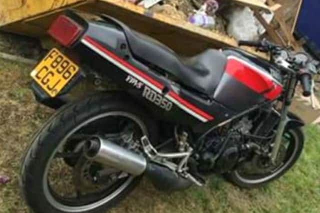 The motorbike pictured by the skip in the park
