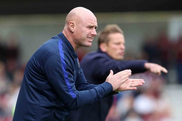 Rob Page encourages his side from the touchline on Saturday, with Dons boss Neal Ardley doing likewise. Pictures: Sharon Lucey