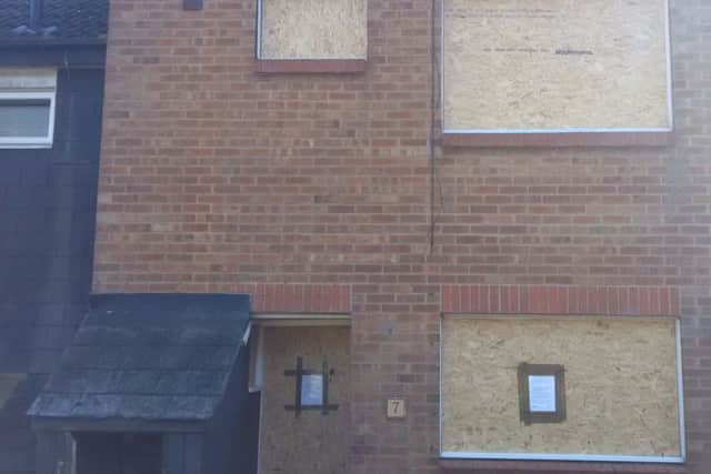 The boarded-up property
