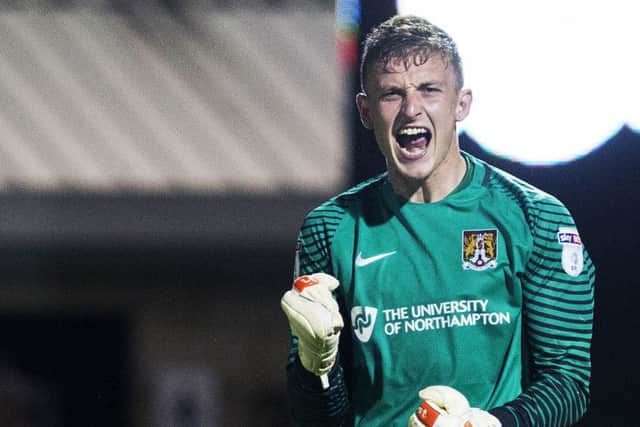 GET IN THERE! - Cobblers goalkeeper Adam Smith celebrates the penalty shootout win over West Brom on Tuesday (Picture: Kirsty Edmonds)