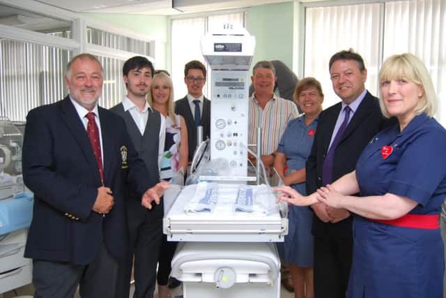 Golf club members and hospital staff with the new device.