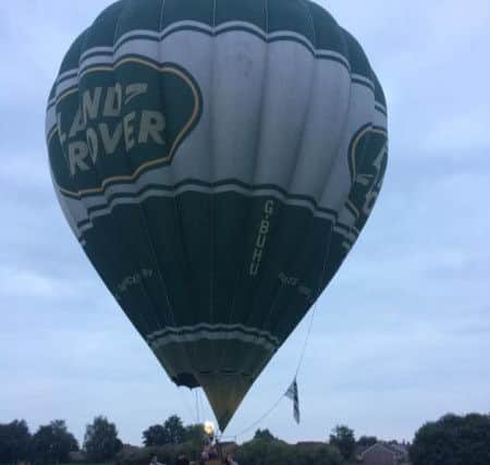 Onlookers helped to bring a hot air balloon to a halt in Rectory Farm Playing Field last night. Picture by Danielle Thomas. aXuYjAJ4nN7KpcMb3TJB