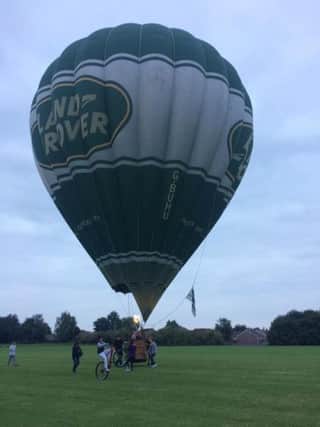 Onlookers helped to bring a hot air balloon to a halt in Rectory Farm Playing Field last night. Picture by Danielle Thomas. aXuYjAJ4nN7KpcMb3TJB