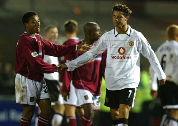 STAR IN THE MAKING - Manchester United's Cristiano Ronaldo shakes hands with Cobblers striker Derek Asamoah at the end of the 2004 FA Cup meeting between the teams (Pictures: Pete Norton)