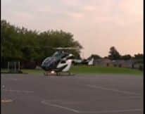A helicopter landed on a primary school playground in Northampton after a girl climbed a lamppost outside the school and fell off.