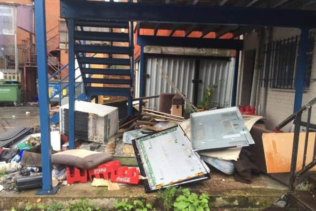 Fly-tipping on a car park at Abington Place has prompted a local lawyer to start clearing it up himself.