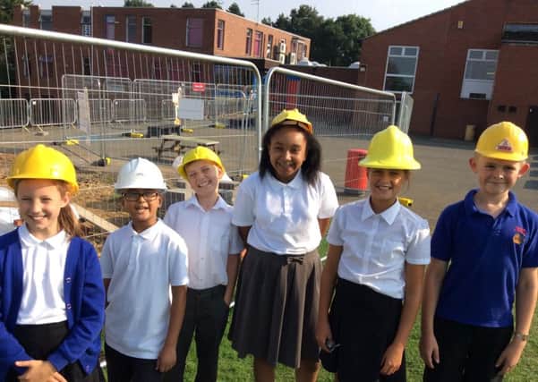 Moulton Primary School pupils with the new extension to the school now rated Good by Ofsted