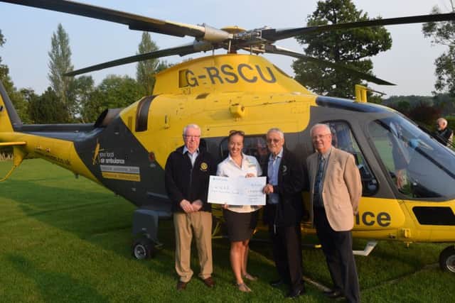 Tracy Grunwell accepts the cheque for £8,000 raised by Northampton Rotarians for the WNAA