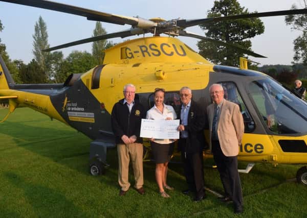 Tracy Grunwell accepts the cheque for Â£8,000 raised by Northampton Rotarians for the WNAA