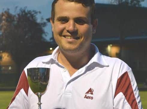 Jamie Walker shows off his county two-wood singles title trophy