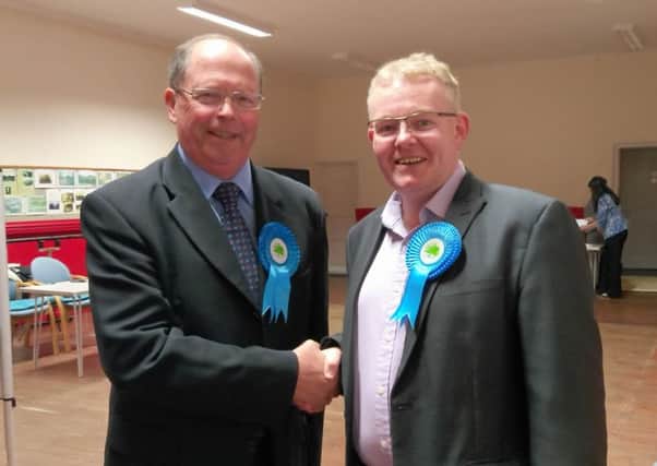 Ken Pritchard (left) being congratulated by Cllr Ian McCord