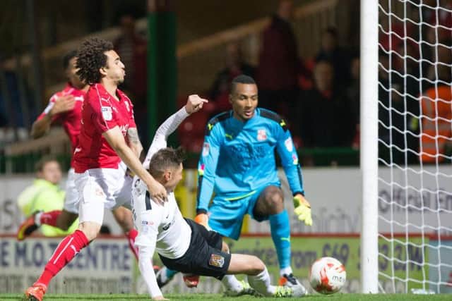 Harry Beautyman slides in to score and fire the Cobblers into the early lead at Swindon Town