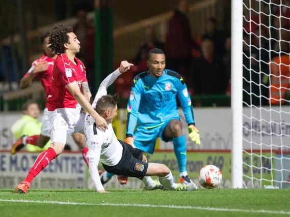 Harry Beautyman slides in to score and fire the Cobblers into the early lead at Swindon Town