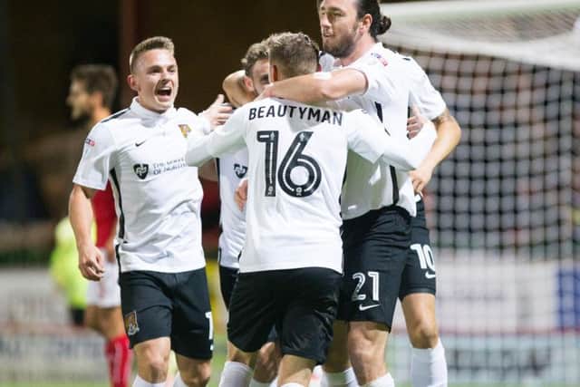 GOAL-DEN BOY - Harry Beautyman is congratulated after firing the Cobblers into an early 1-0 lead in their 3-1 win at Swindon Town